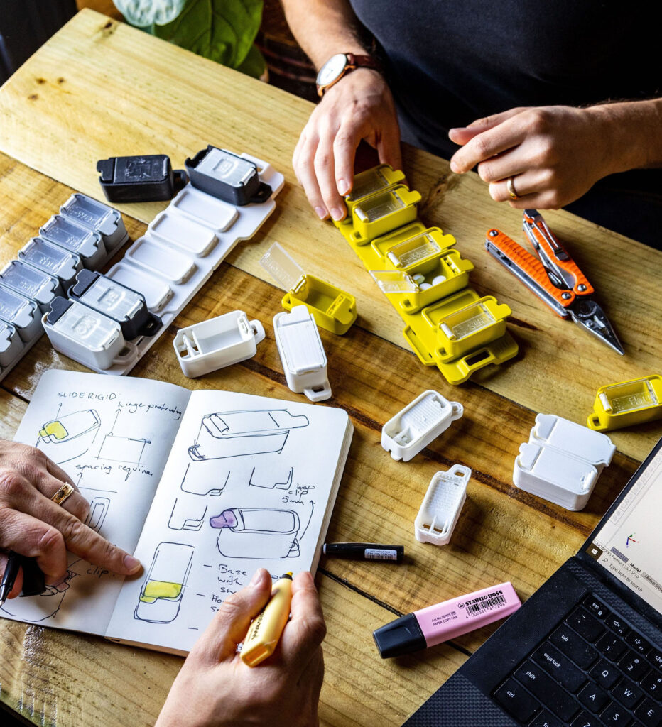 Closeup of our hands as we test and fiddle with a product. We’re also taking notes and sketching alternative designs.
